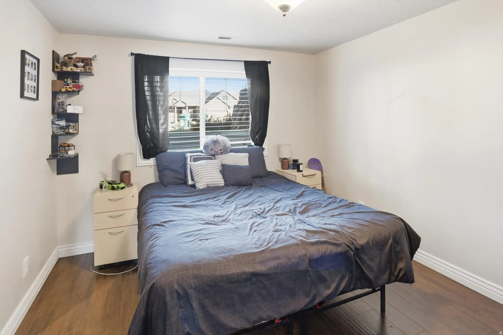 Bedroom with baseboards and dark wood-style floors