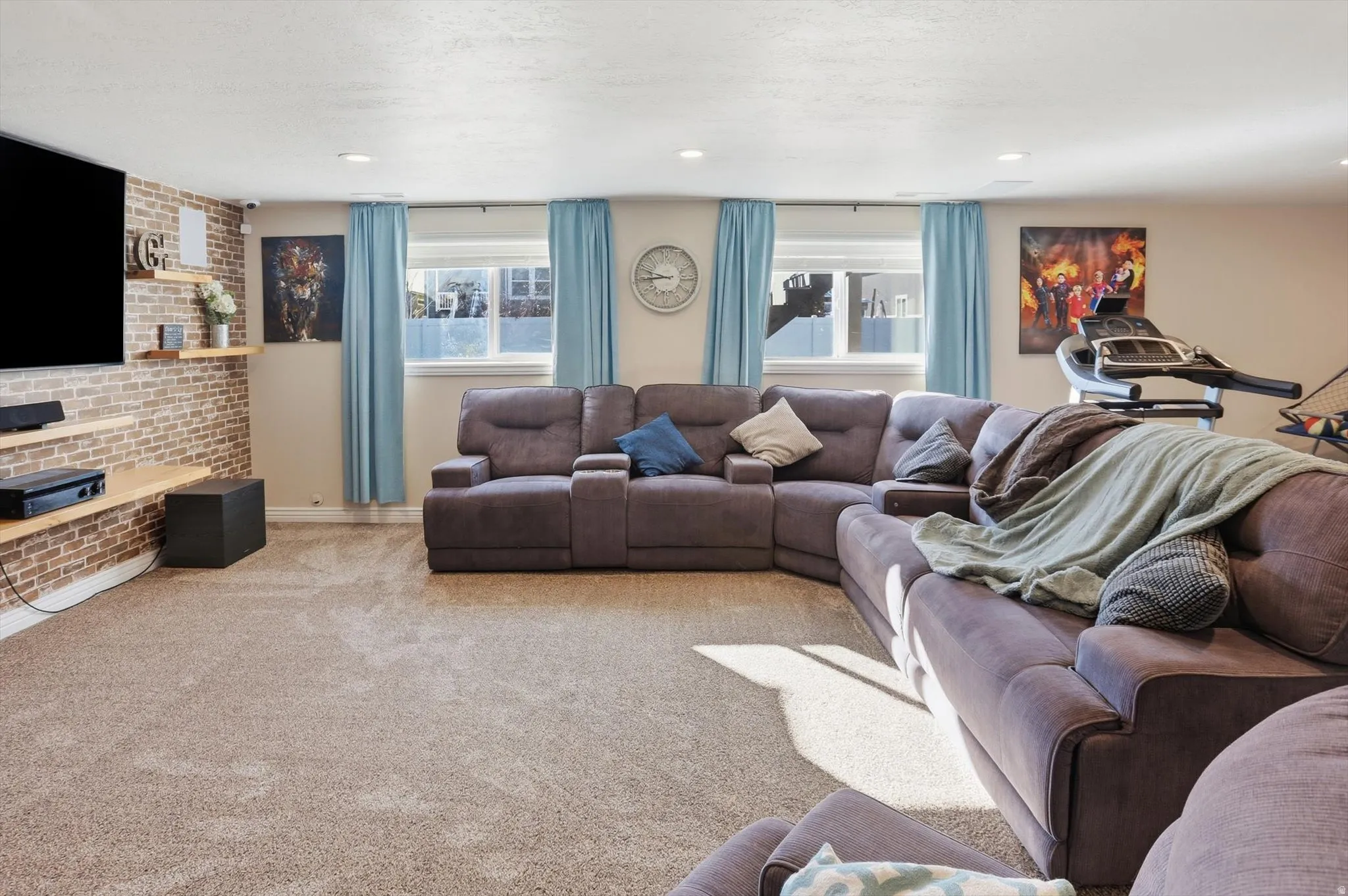 Living area featuring carpet flooring and baseboards