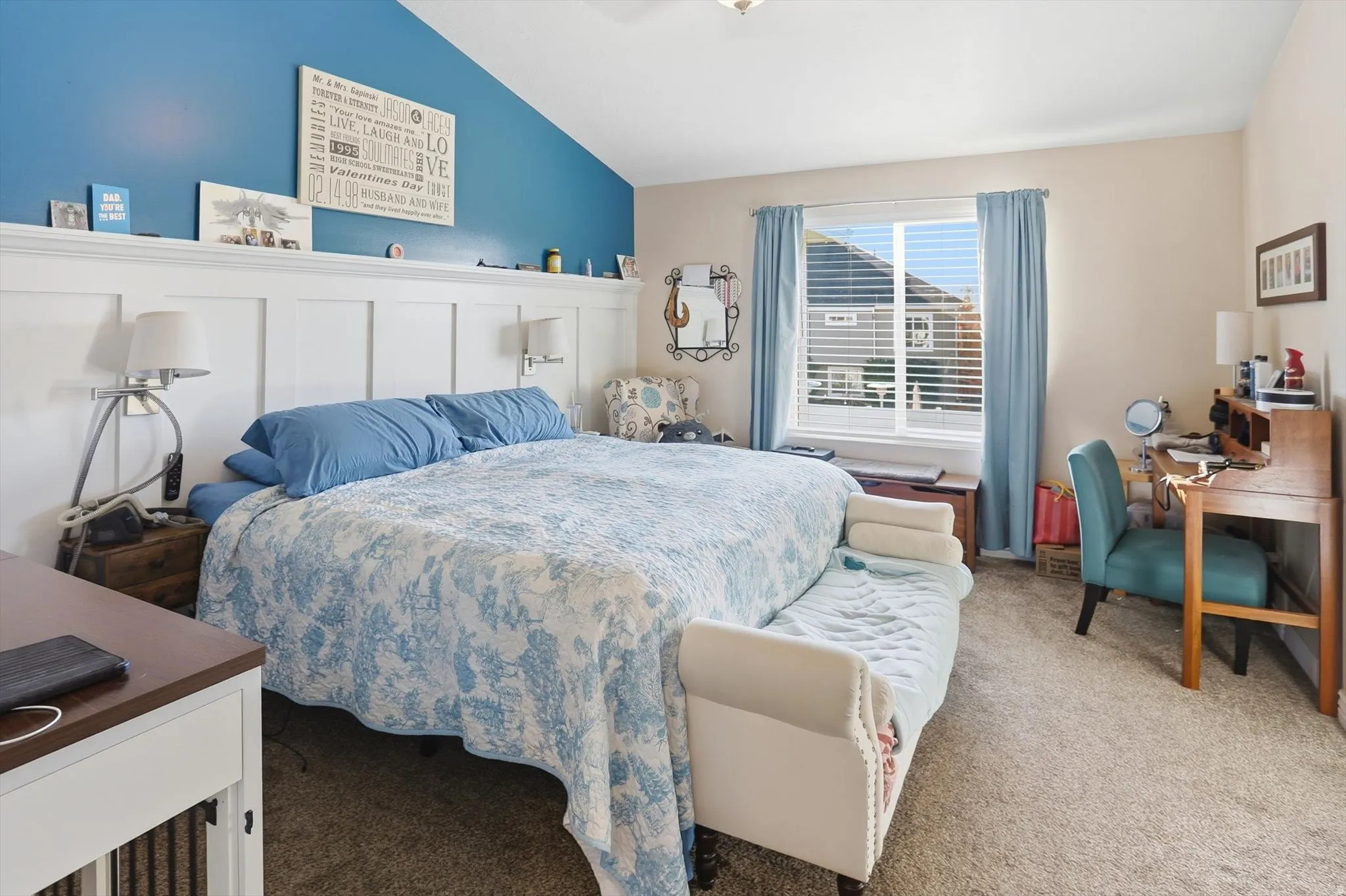 Bedroom with carpet floors, vaulted ceiling, an office area, and a ceiling fan