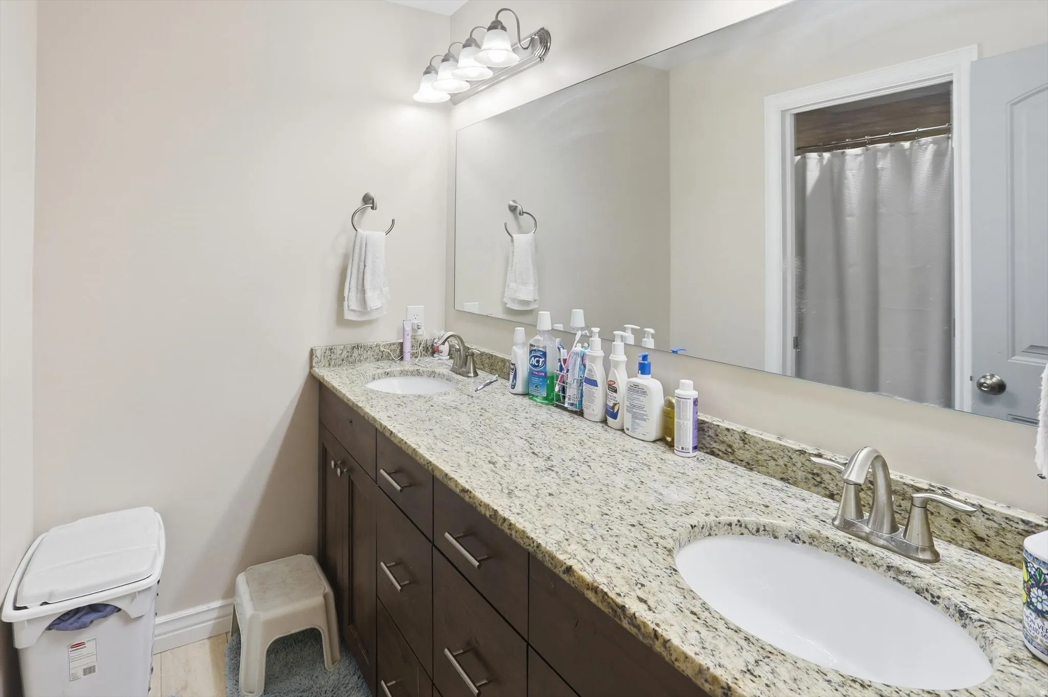 Bathroom featuring double vanity and a shower with curtain