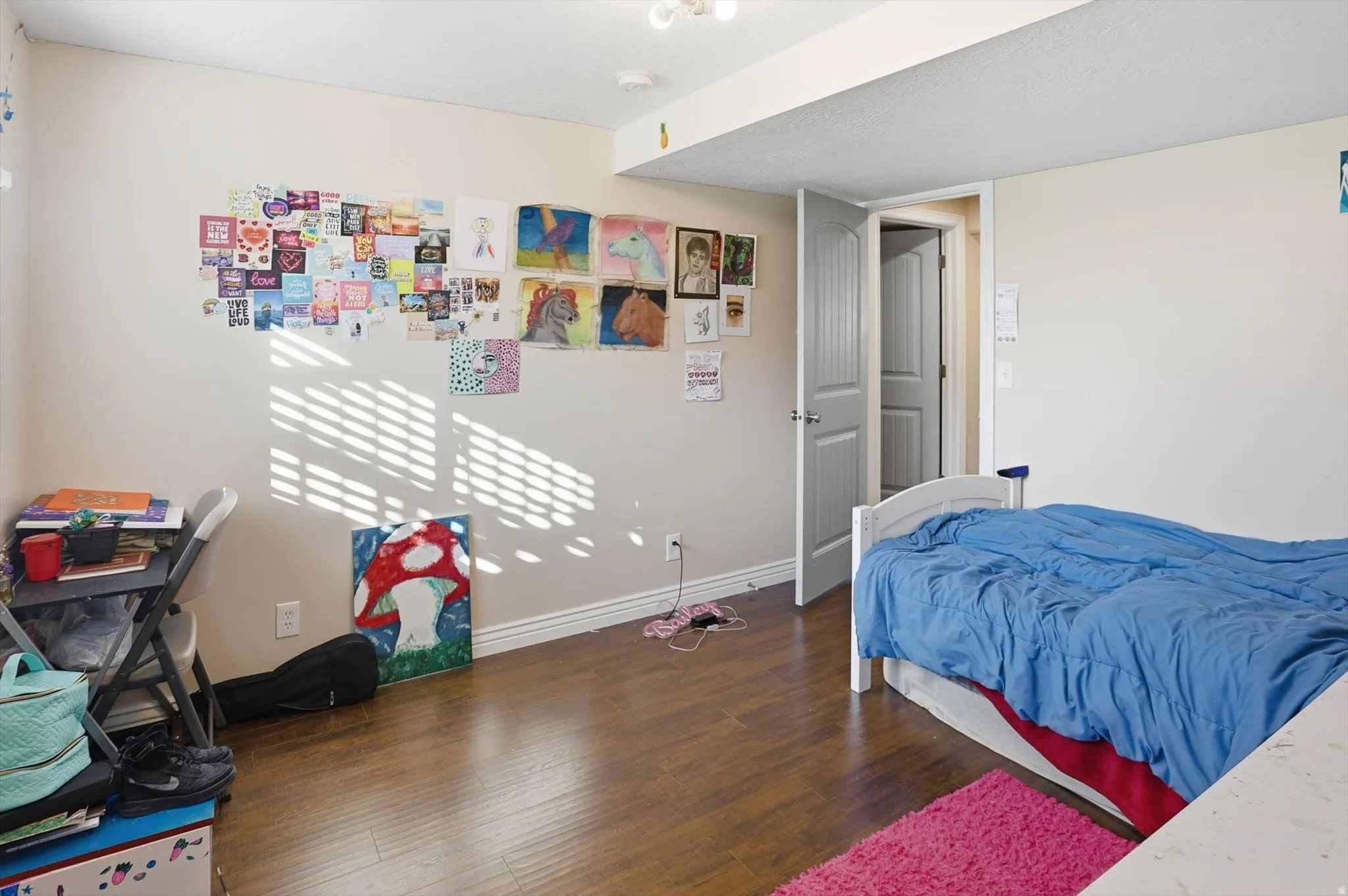 Bedroom featuring baseboards and dark wood-style floors