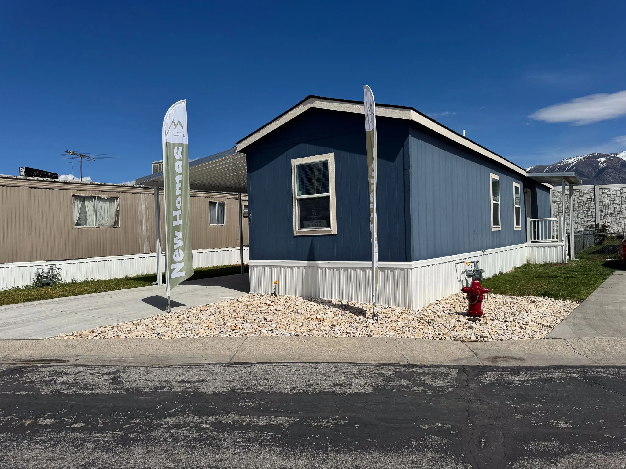 Manufactured / mobile home with an attached carport, driveway, and a mountain view