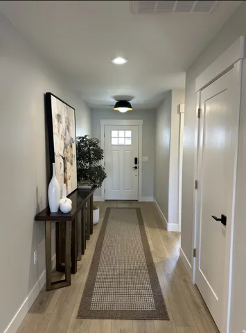 Entryway featuring hardwood / wood-style floors and recessed lighting