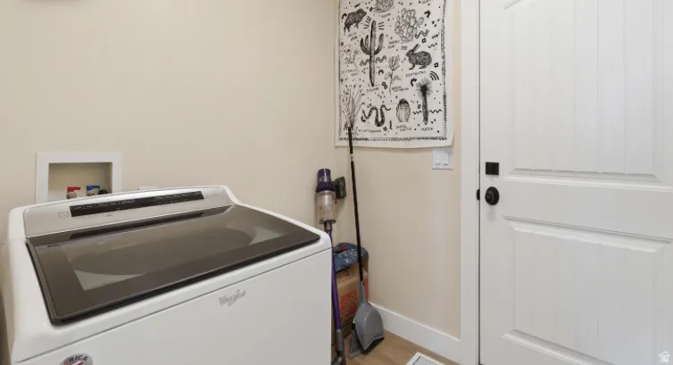 Washroom featuring washer / dryer and baseboards