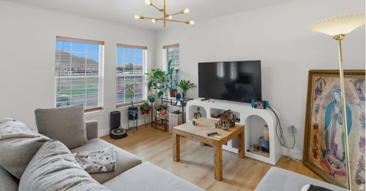 Living area with a chandelier and light wood-type flooring