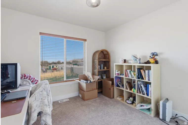 Office space with light carpet and baseboards