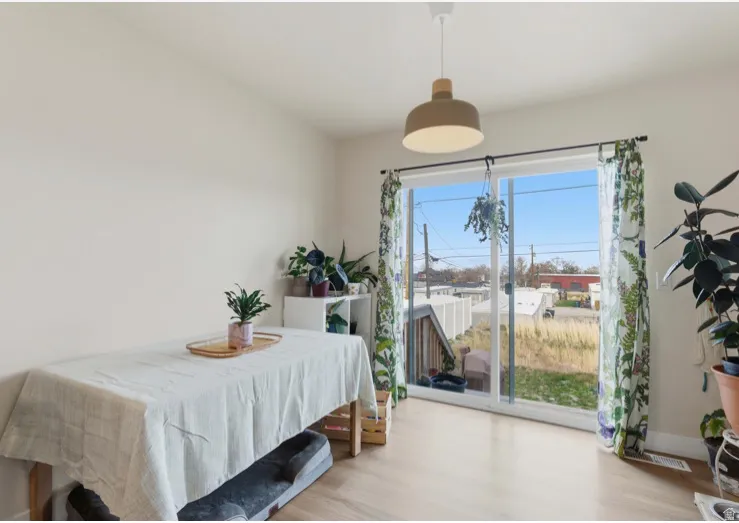 Bedroom with wood finished floors and baseboards
