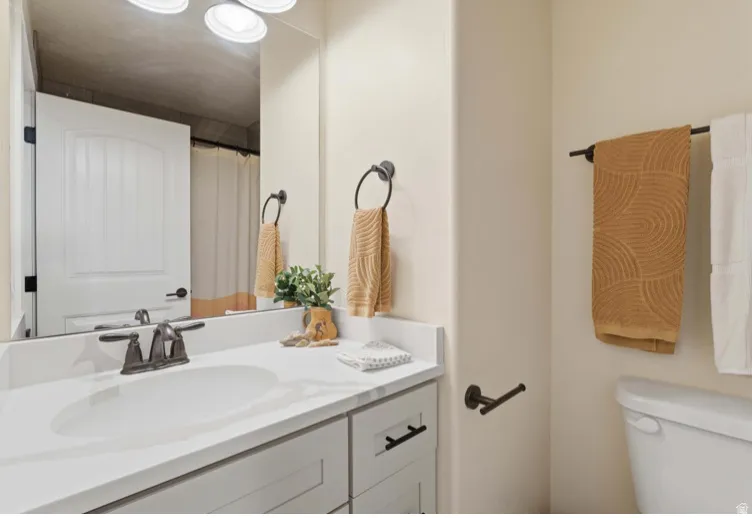 Bathroom with curtained shower and vanity