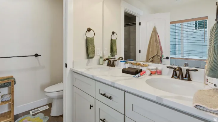 Full bathroom with double vanity and a shower