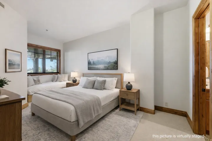 Spacious room featuring wood-trimmed windows with horizontal blinds, a built-in window bench, light-colored walls, and wood trim
