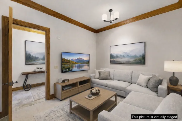 Living area featuring exposed wood ceiling beams and matching door frames