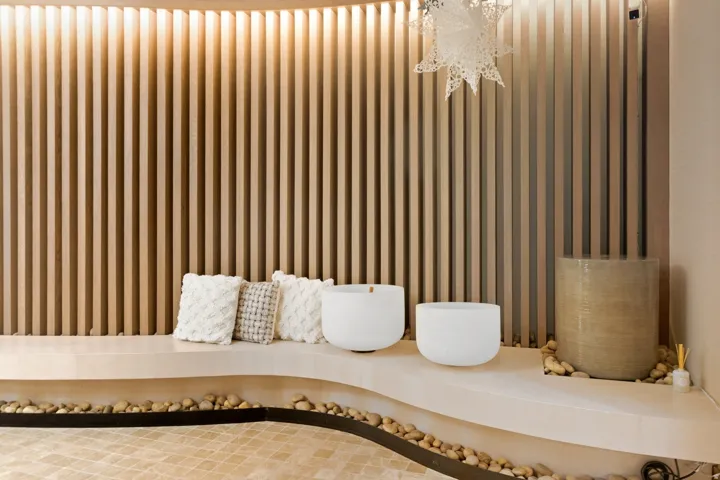 Wood-slat wall paneling with integrated cove lighting
