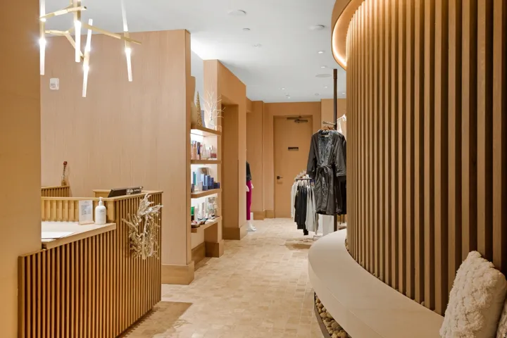 Entryway featuring wood slat paneling, recessed lighting, and a modern chandelier