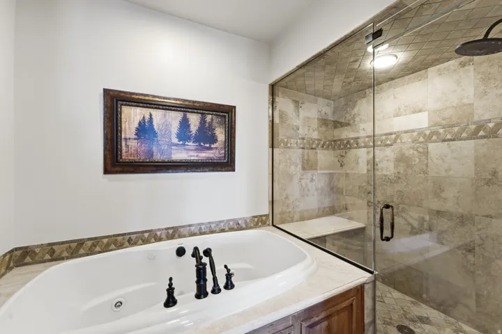Spacious bathroom with a built-in soaking tub featuring dark bronze fixtures