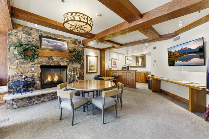 Stone-clad fireplace with a wood mantel and hearth