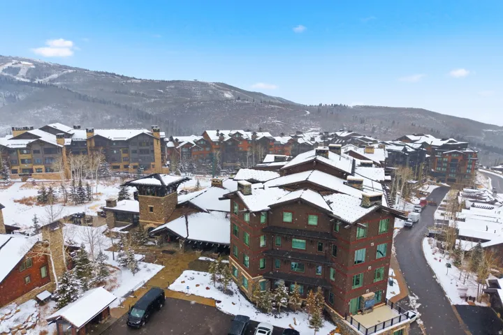 Community of multi-story buildings featuring stone and wood-finish exteriors