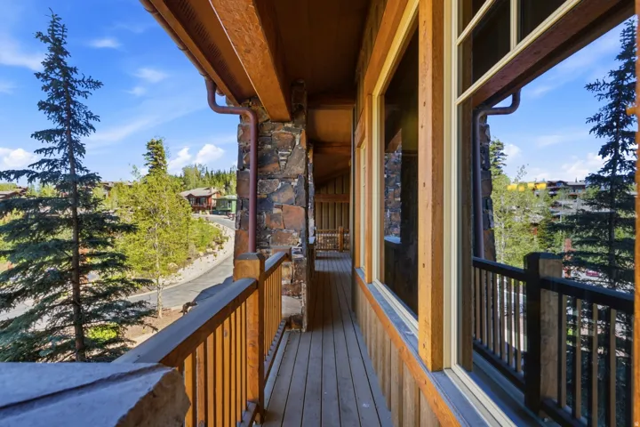 Exterior balcony featuring natural wood decking and railings