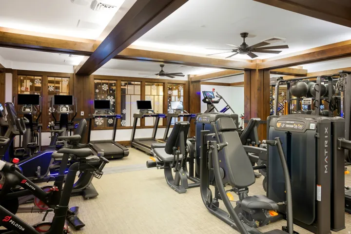 Well-appointed fitness facility featuring exercise equipment, treadmills, and stationary bikes