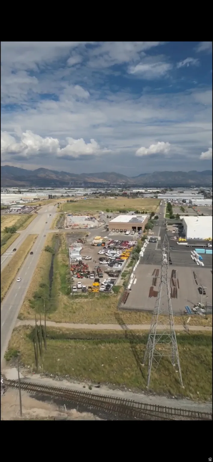 Aerial view of property and surrounding area with a mountainous background