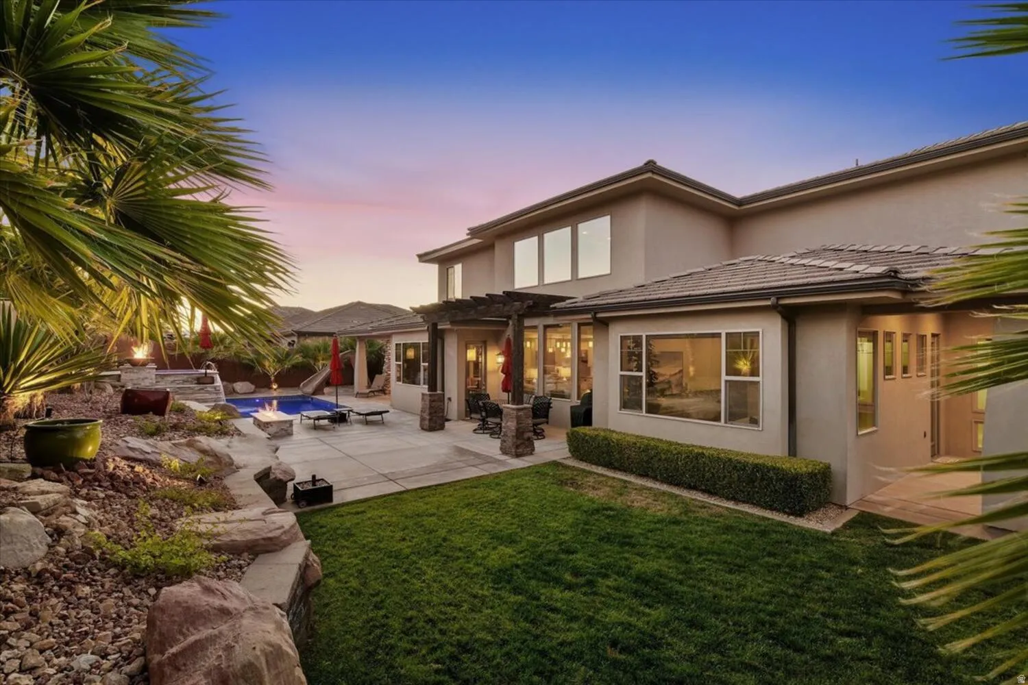 Rear view of property with an outdoor pool, a patio, stucco siding, a pergola, and a tile roof