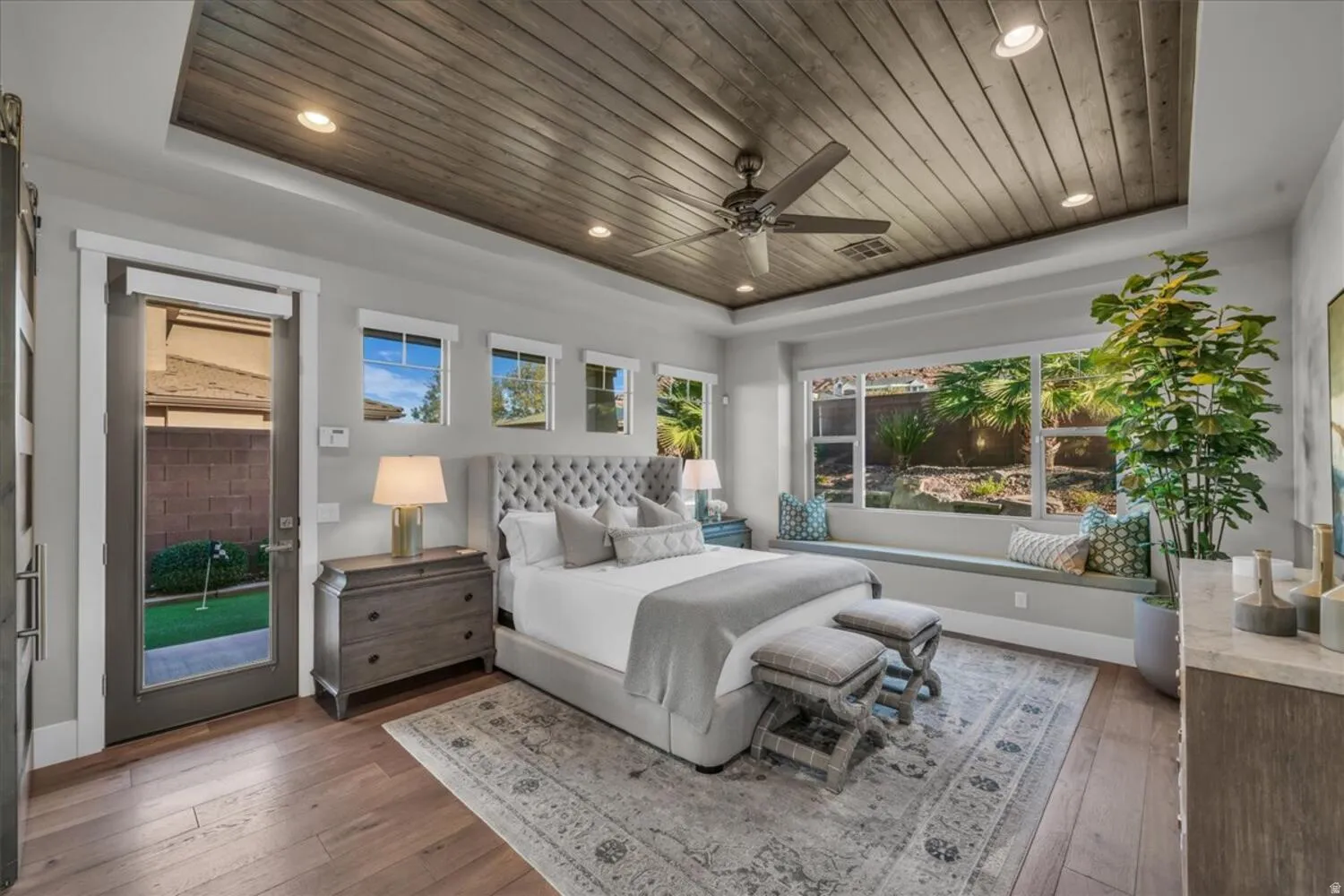 Bedroom featuring a tray ceiling, wooden ceiling, hardwood / wood-style floors, access to outside, and a ceiling fan