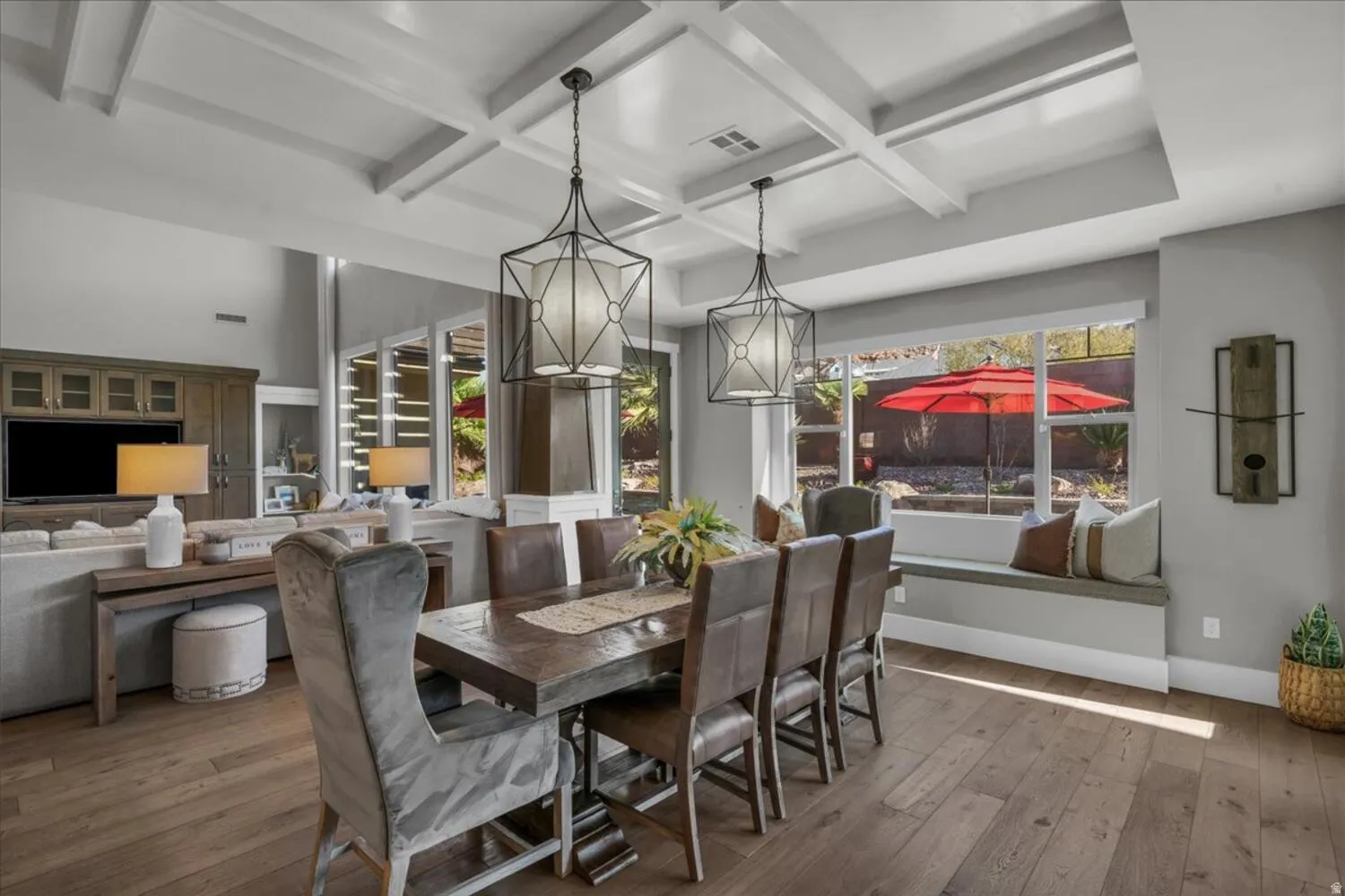 Dining room featuring coffered ceiling, hardwood / wood-style flooring, and beamed ceiling