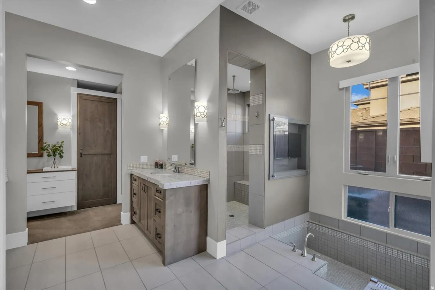 Full bathroom featuring vanity, walk in shower, light tile patterned floors, and light carpet