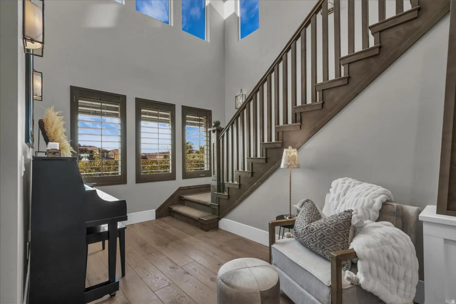 Stairway featuring hardwood / wood-style floors and a high ceiling