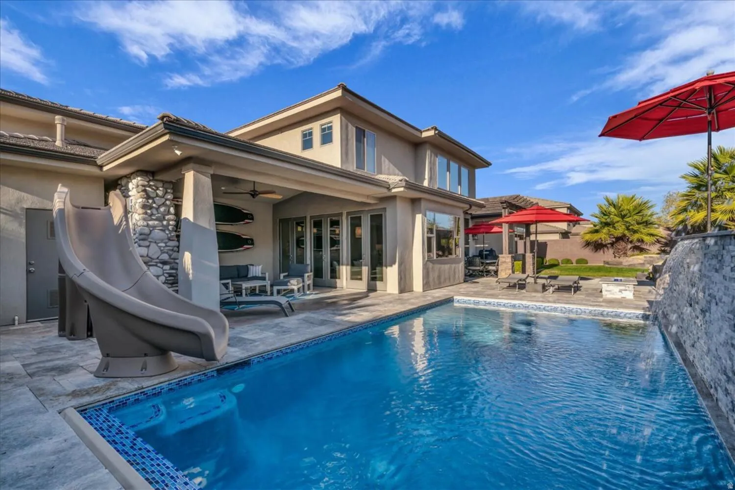 Outdoor pool with a water slide, a patio, an outdoor living space, and outdoor dining space