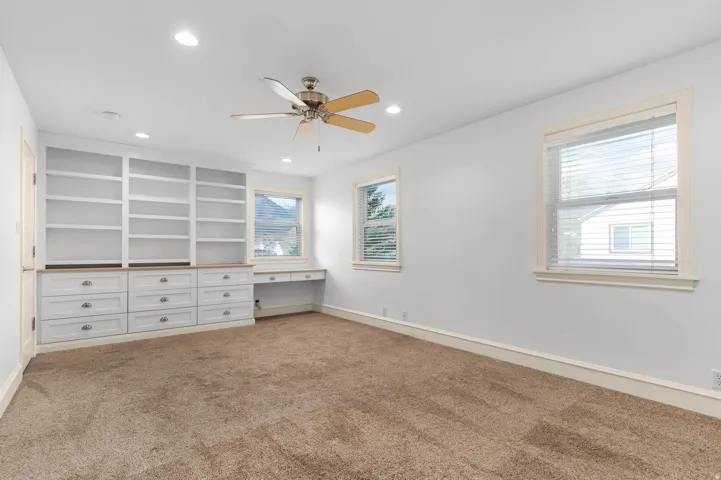 Unfurnished bedroom featuring recessed lighting, a ceiling fan, and light colored carpet