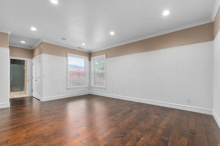 Unfurnished room with crown molding, dark wood-style flooring, and recessed lighting