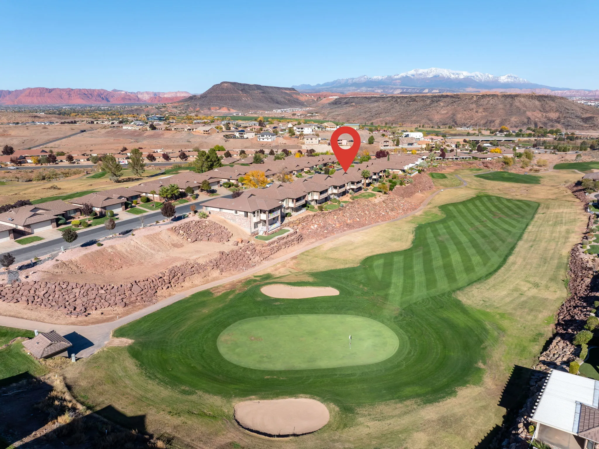 Aerial overview of property's location featuring mountains and nearby suburban area