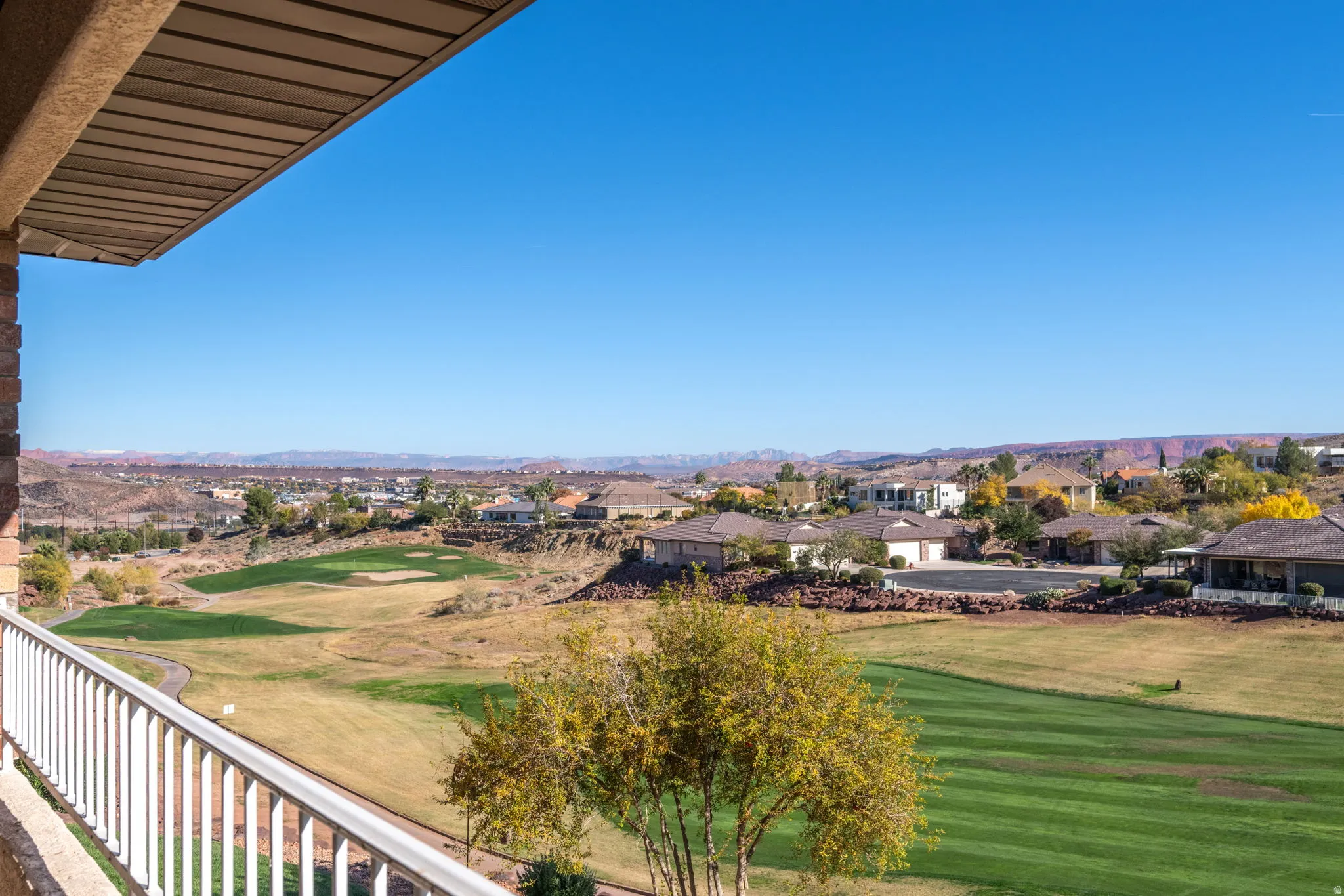 Balcony with view of golf course and a residential view