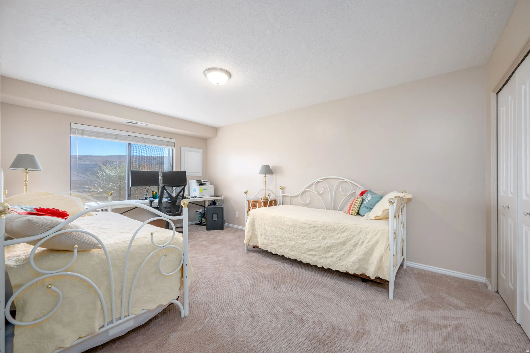 Bedroom with carpet, a closet, and a desk