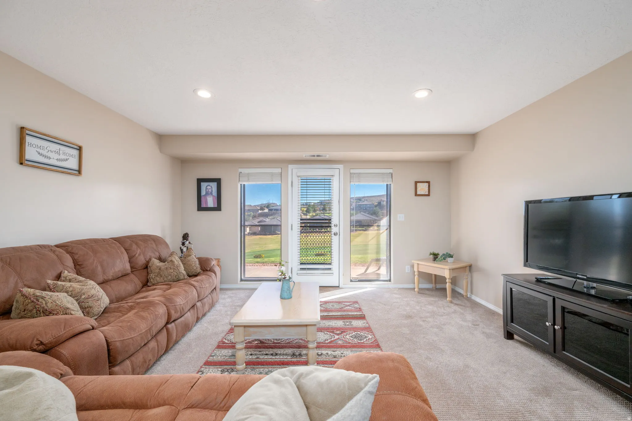 Carpeted living room with recessed lighting and baseboards