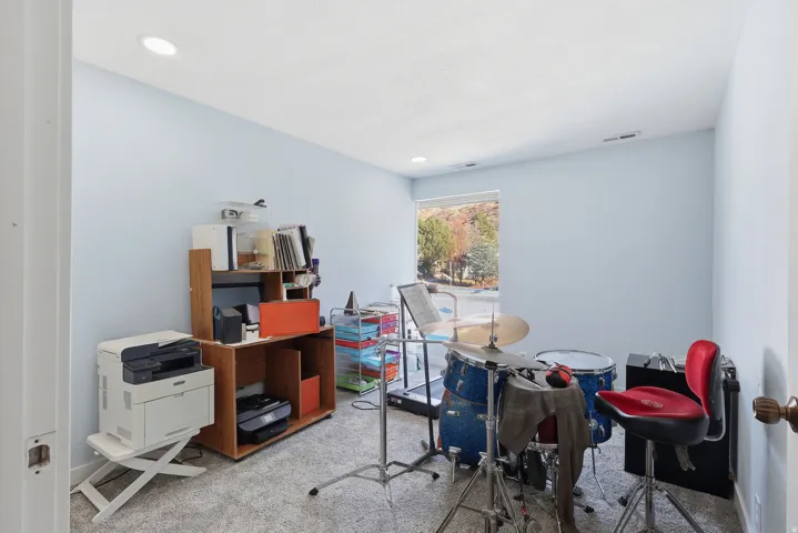 Carpeted office space featuring recessed lighting
