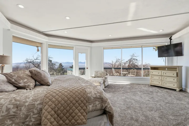 Carpeted bedroom featuring access to exterior and recessed lighting