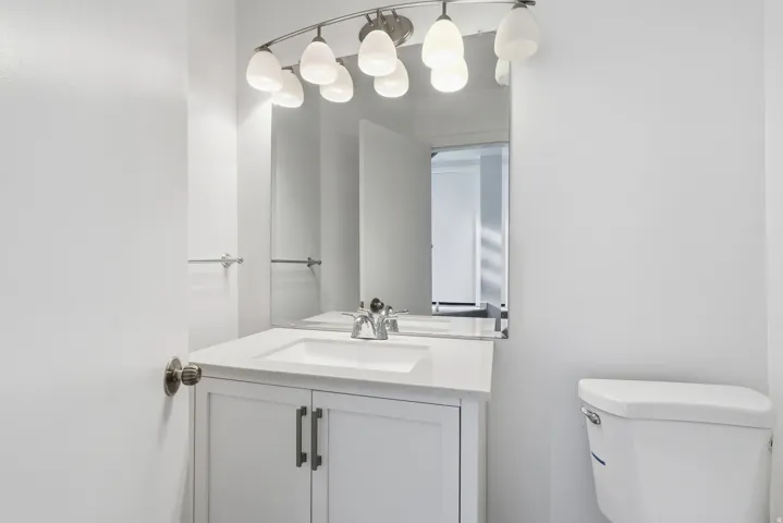 Half bath featuring vanity and toilet