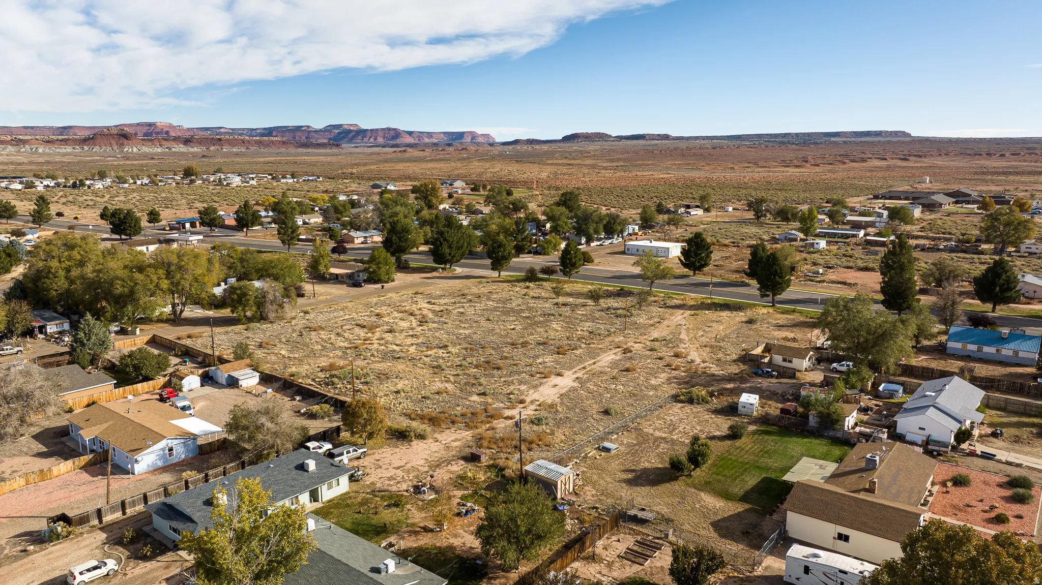 Overview of rural landscape with nearby suburban area and mountains