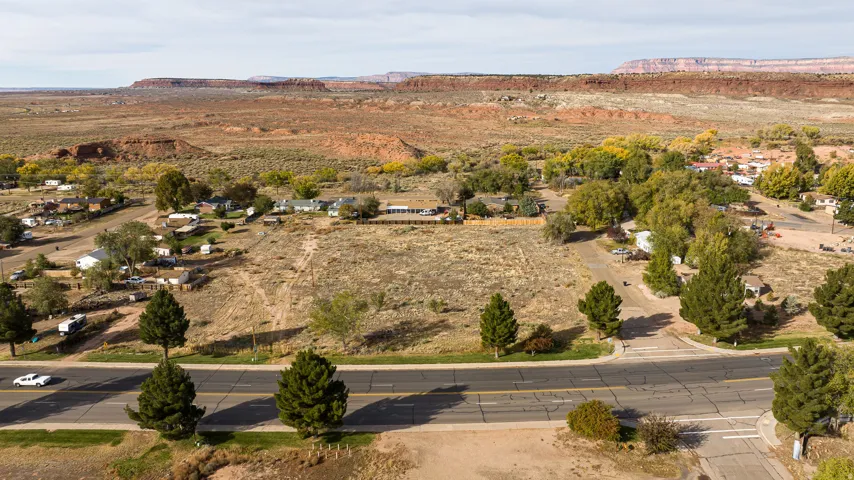 Aerial view of property and surrounding area with a mountainous background
