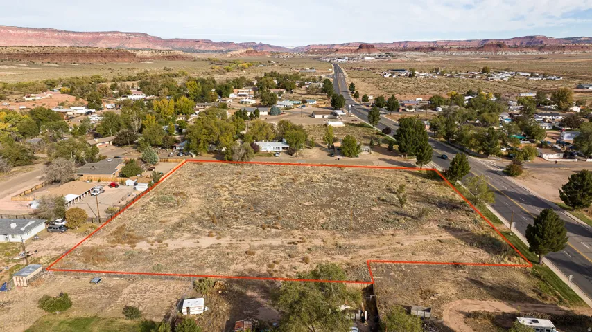 Aerial view of sparsely populated area featuring mountains and property boundaries highlighted