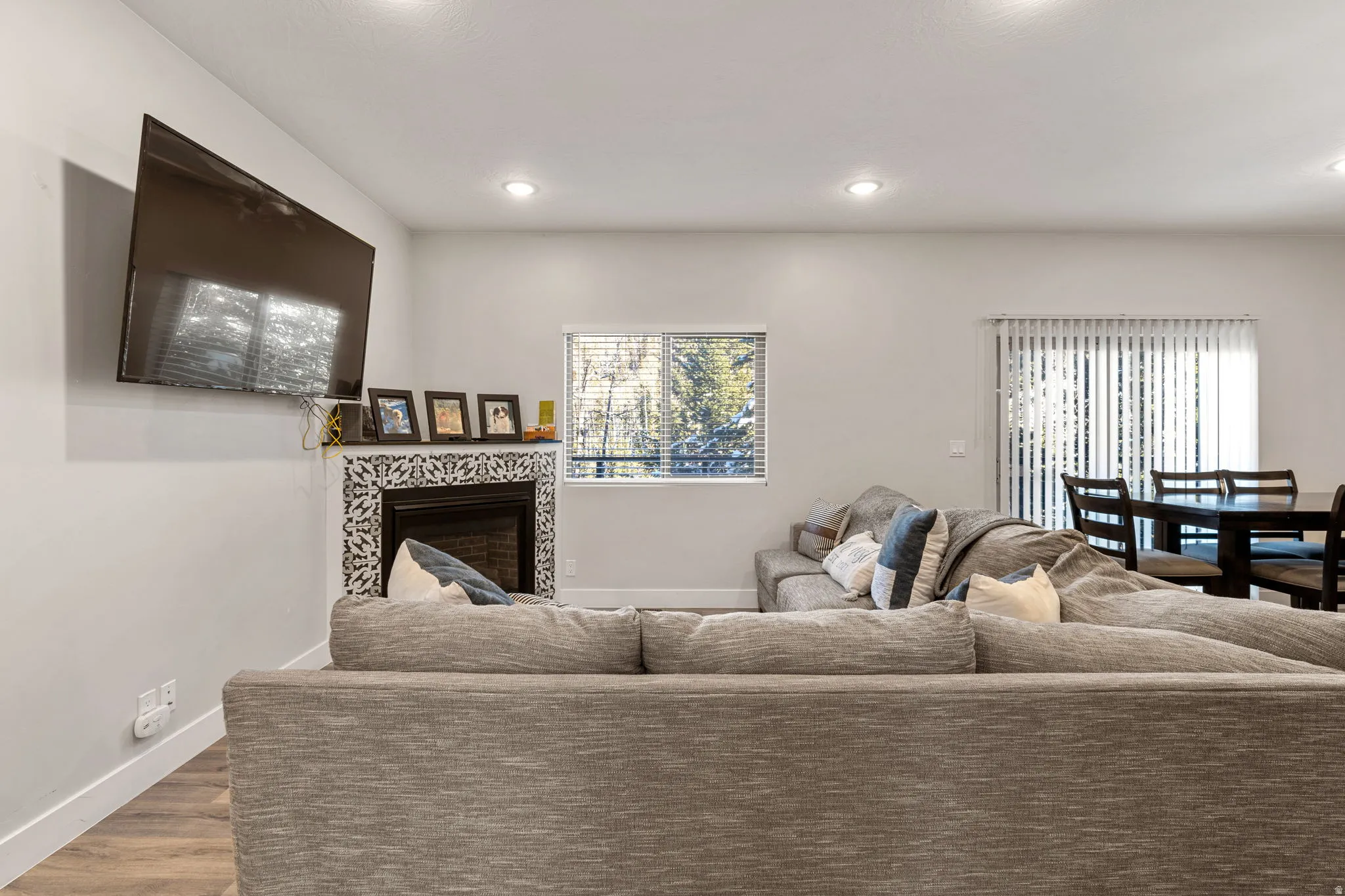 Living area with wood finished floors, recessed lighting, and plenty of natural light