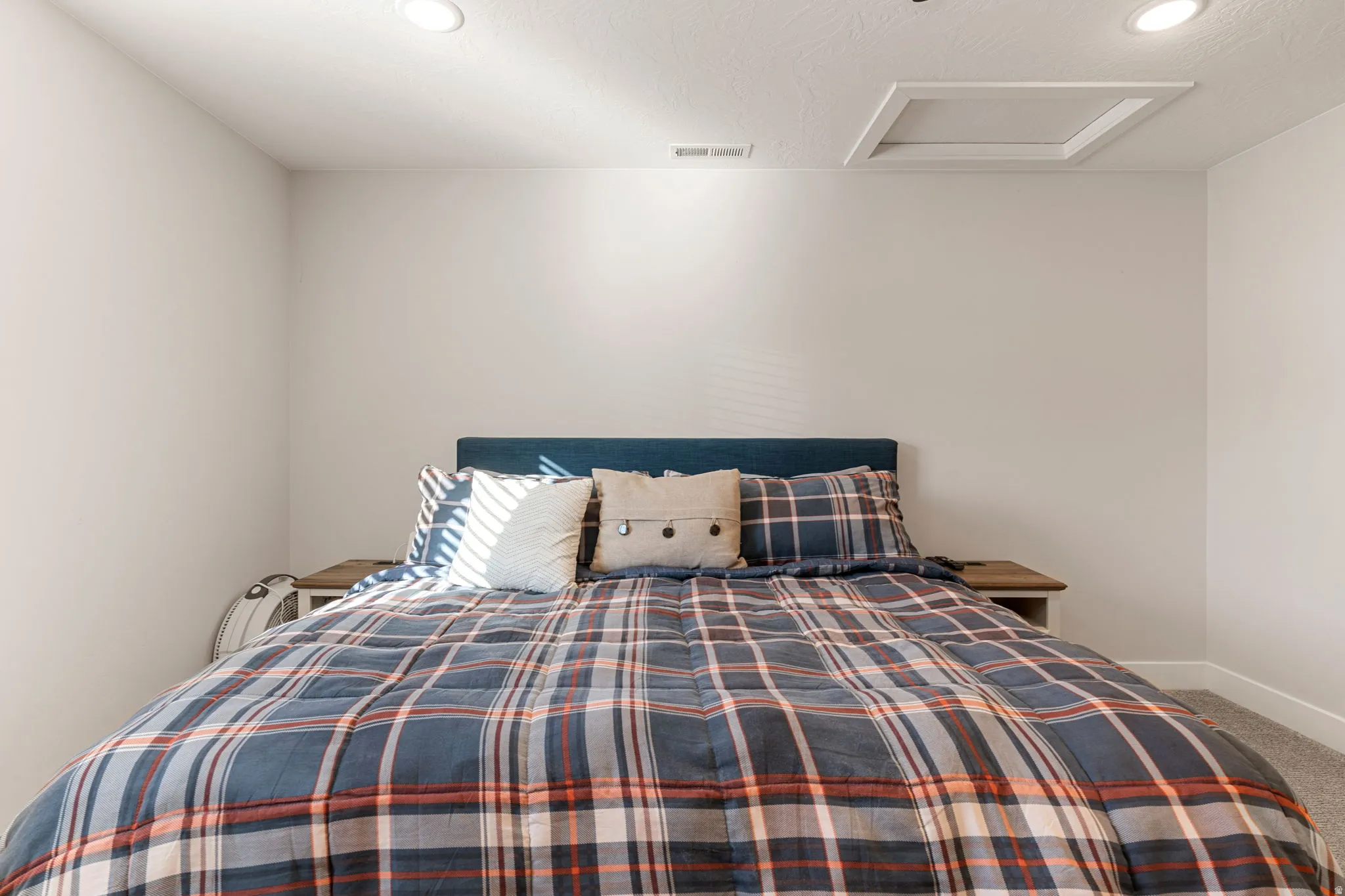 Carpeted bedroom with attic access and recessed lighting