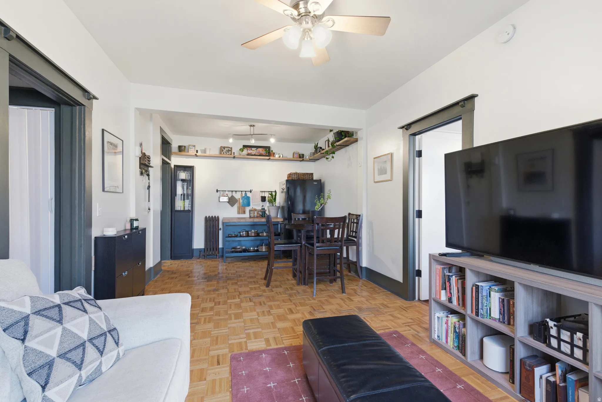 Living room featuring a ceiling fan and baseboards