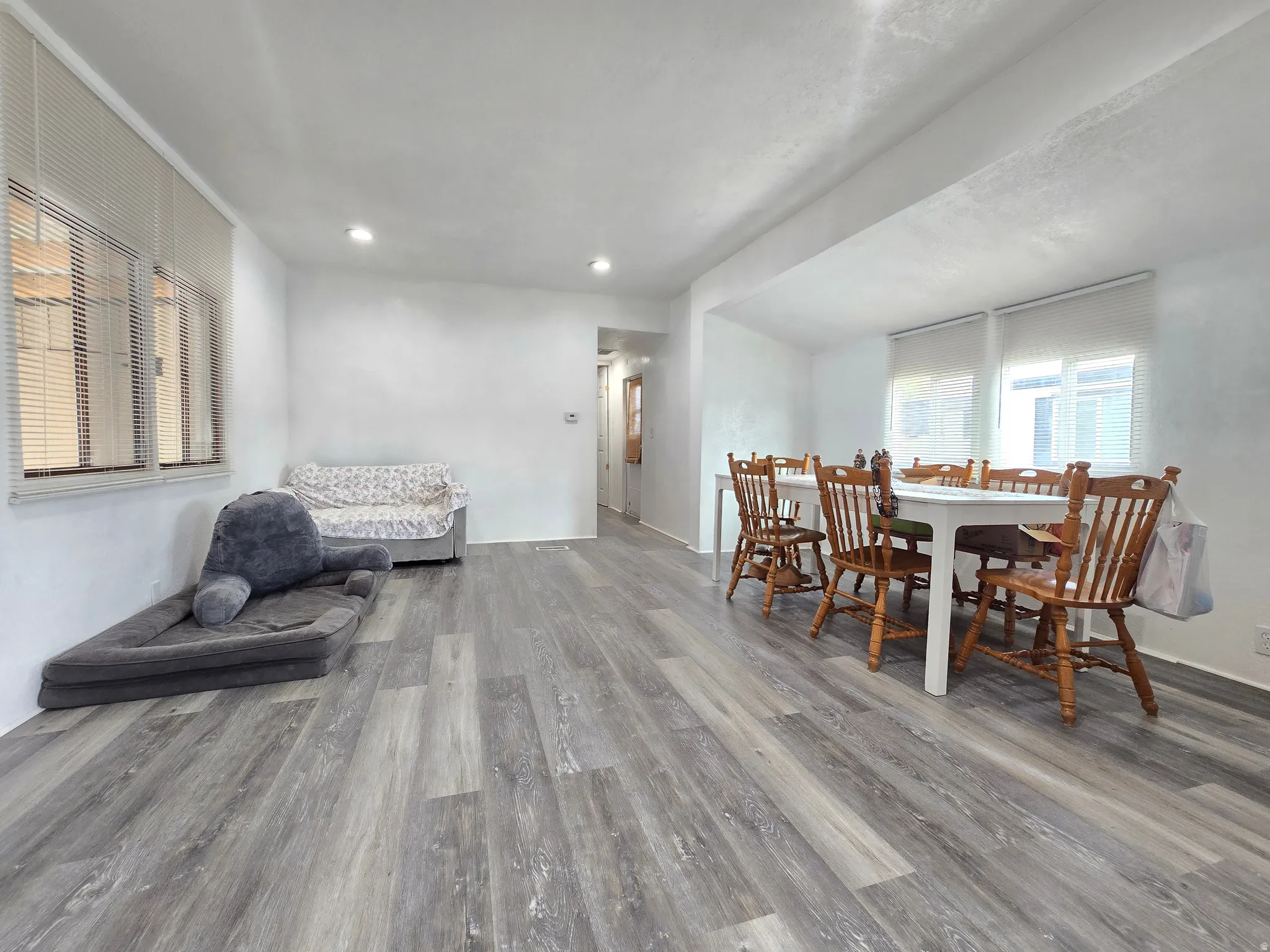 Dining area with wood finished floors and recessed lighting