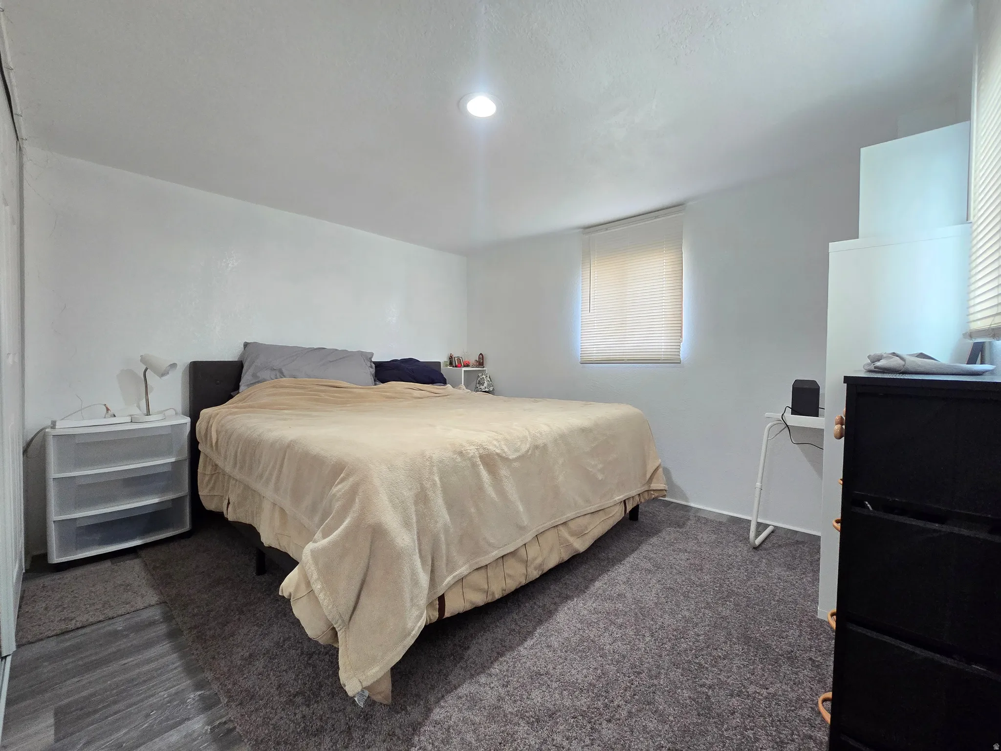 Carpeted bedroom with a textured ceiling