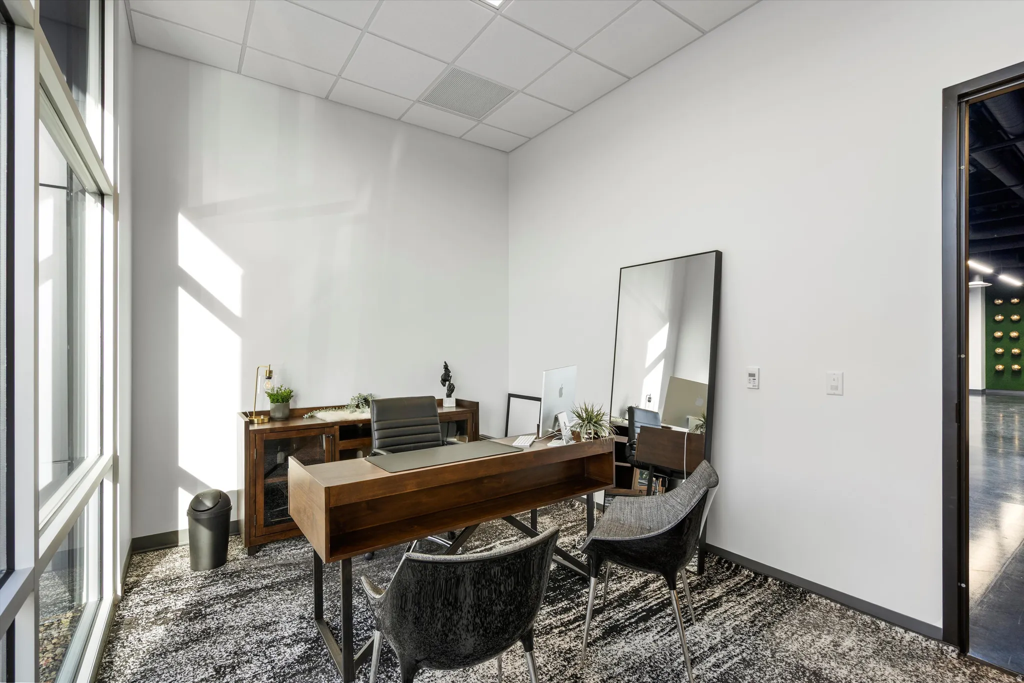 Home office with a paneled ceiling and a towering ceiling