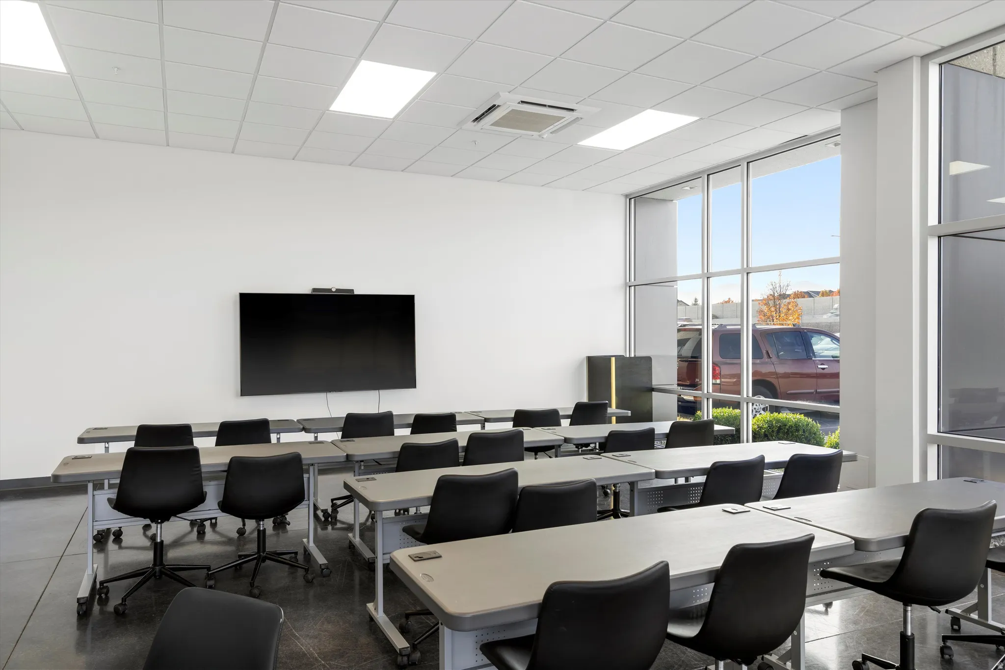 Home office featuring floor to ceiling windows and a paneled ceiling