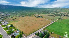 Aerial view of property and surrounding area with rural landscape and a mountainous background
