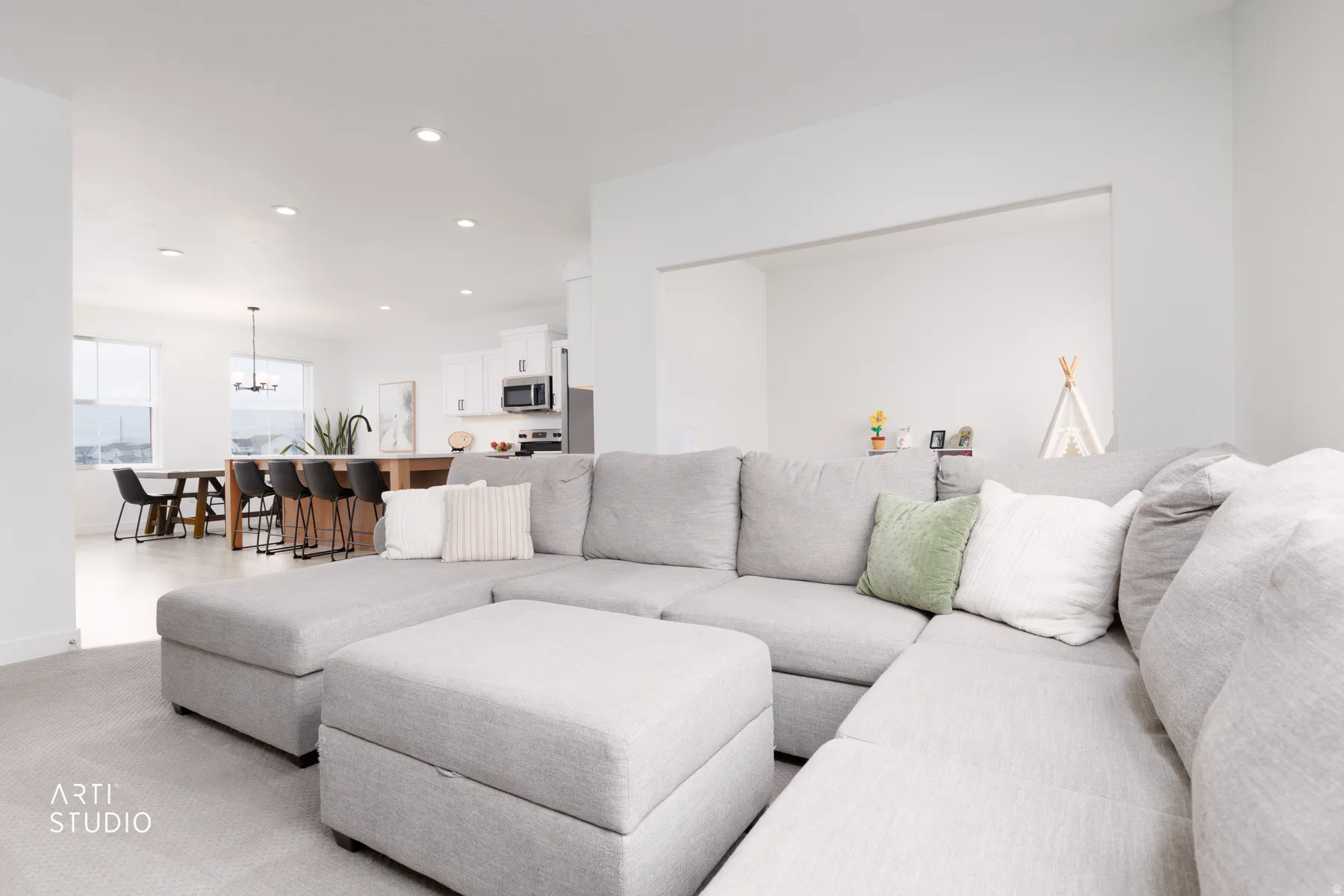 Living area with recessed lighting and a chandelier